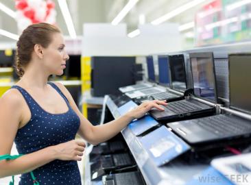 woman-looking-at-laptops-in-store